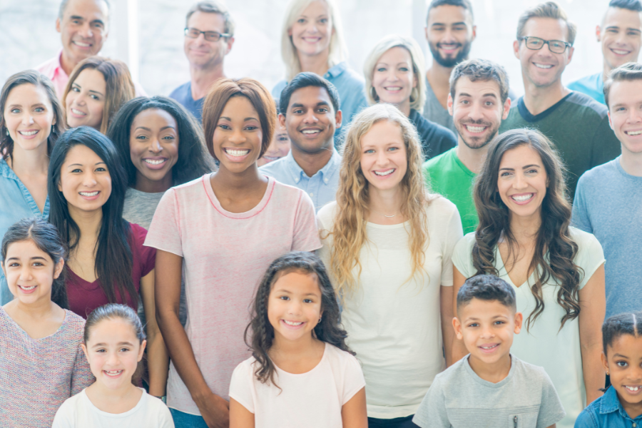 donate to your community. Large group of diverse people smiling at the camera
